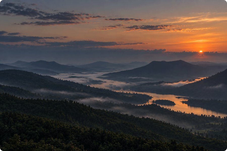 Misty mountain river valley at sunrise
